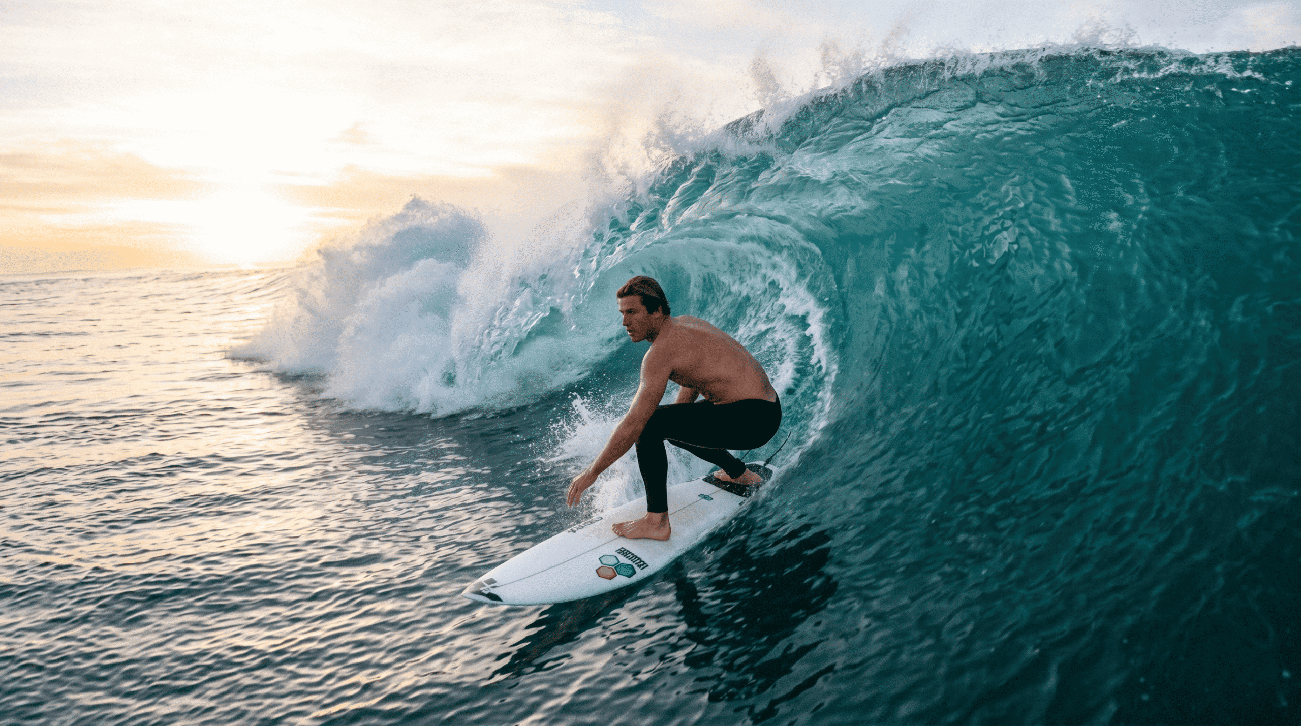 surf maneuvers: An experienced surfer striking the vertical lip of a wave during a powerful re-entry.